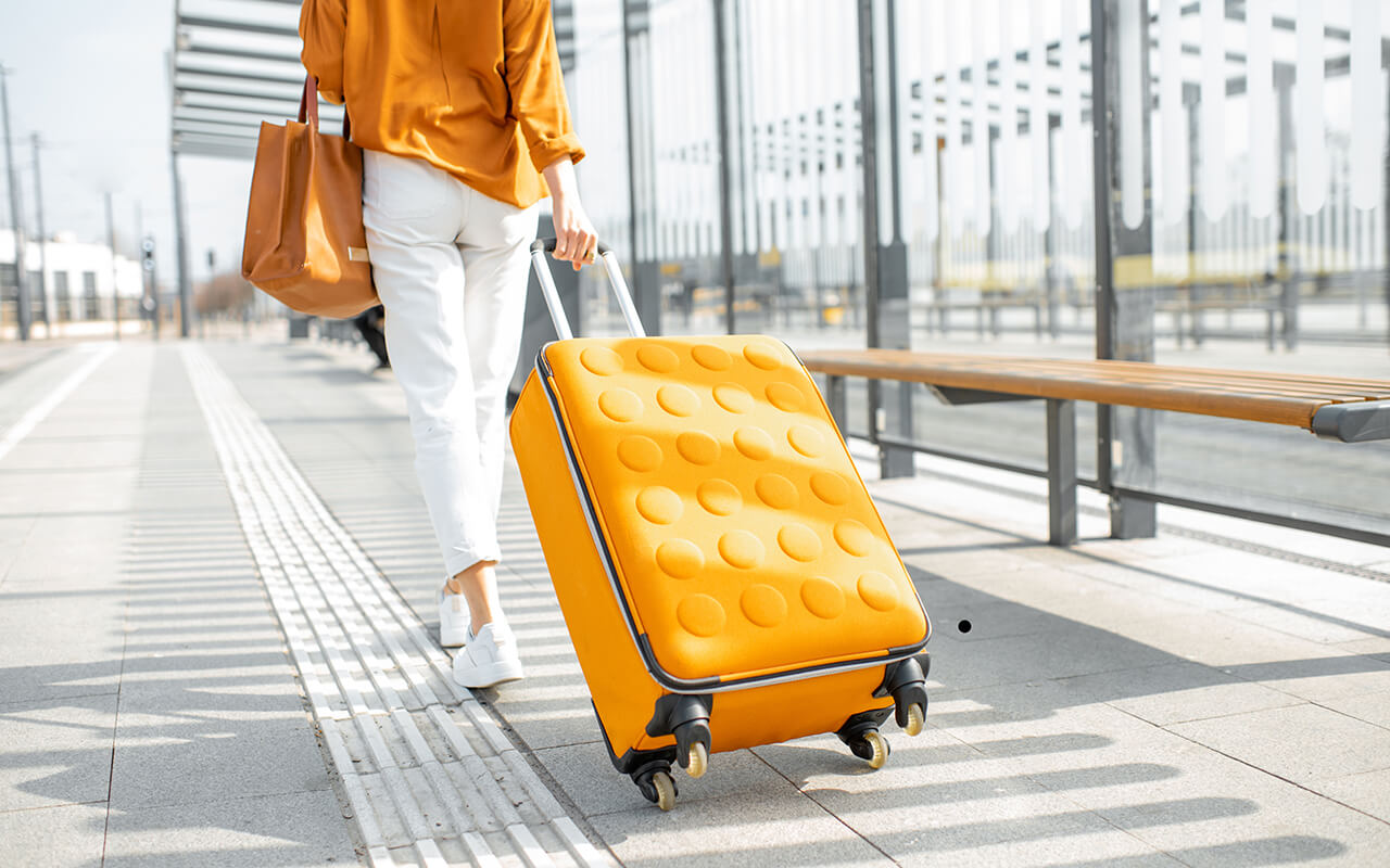 Woman walking in the airport with a suitcase