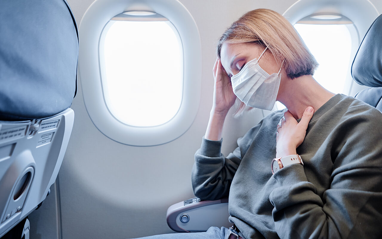 Woman feeling sick on an airplane