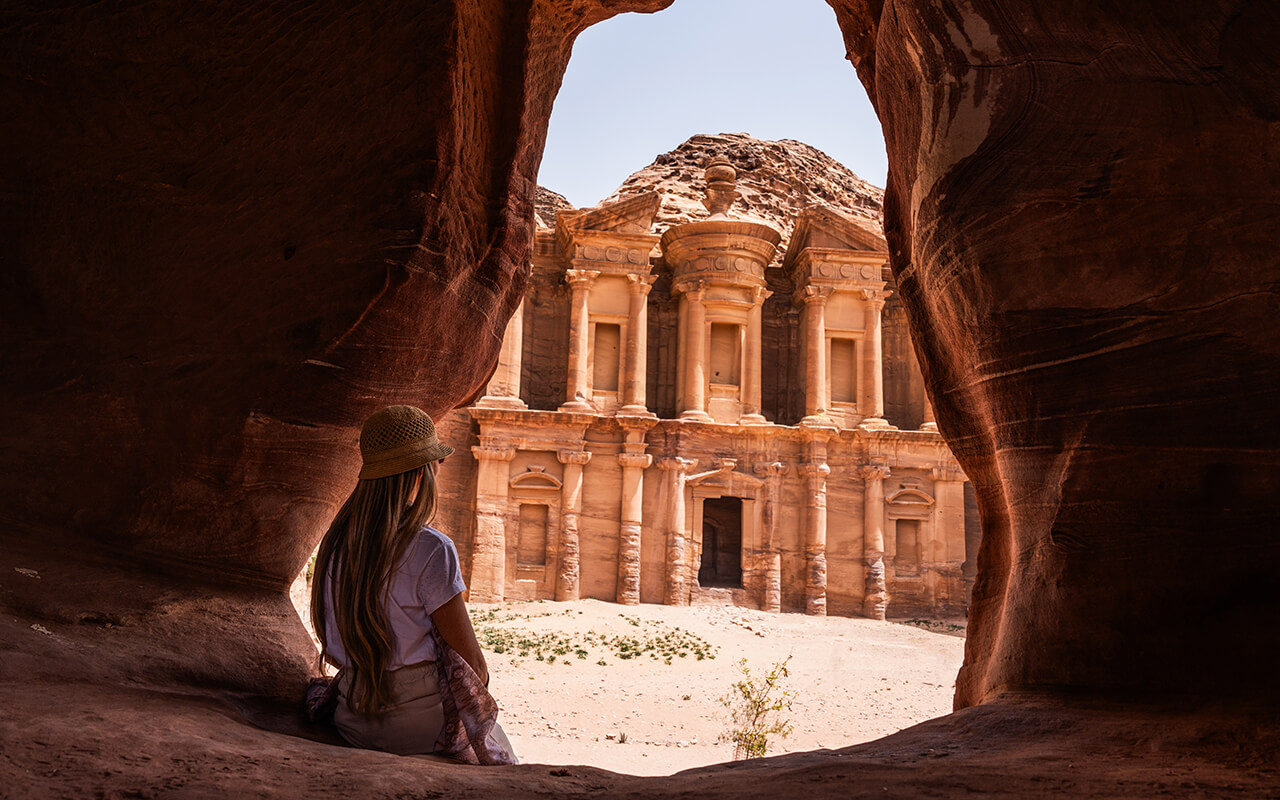 Blonde woman in viewpoint of The Monastery, ancient city of Petra, Jordan