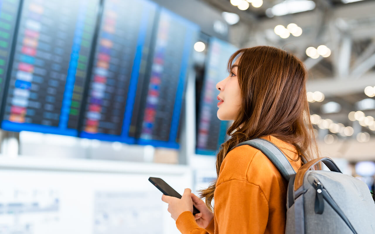 Woman looking at upcoming flights at the airport