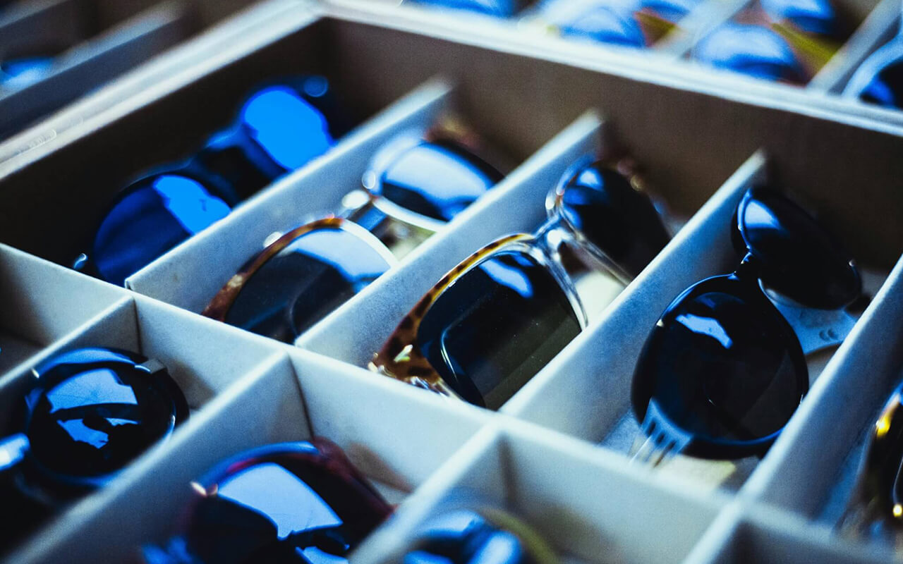 Sunglasses organized in boxes.