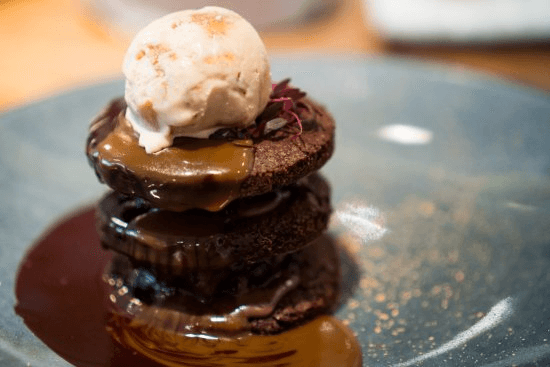 Chocolate cake with ice cream on top
