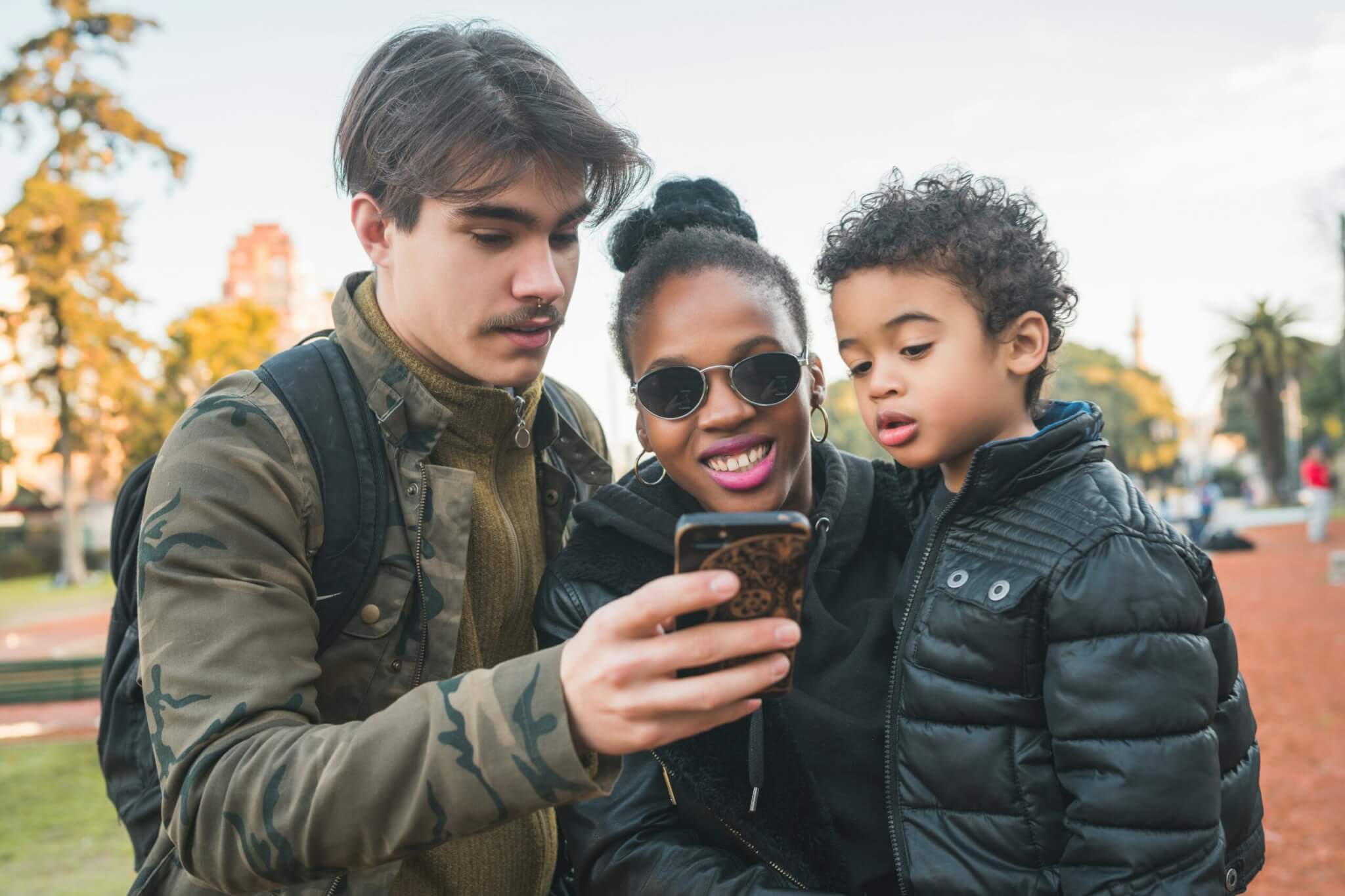 Family gathered around a smartphone 