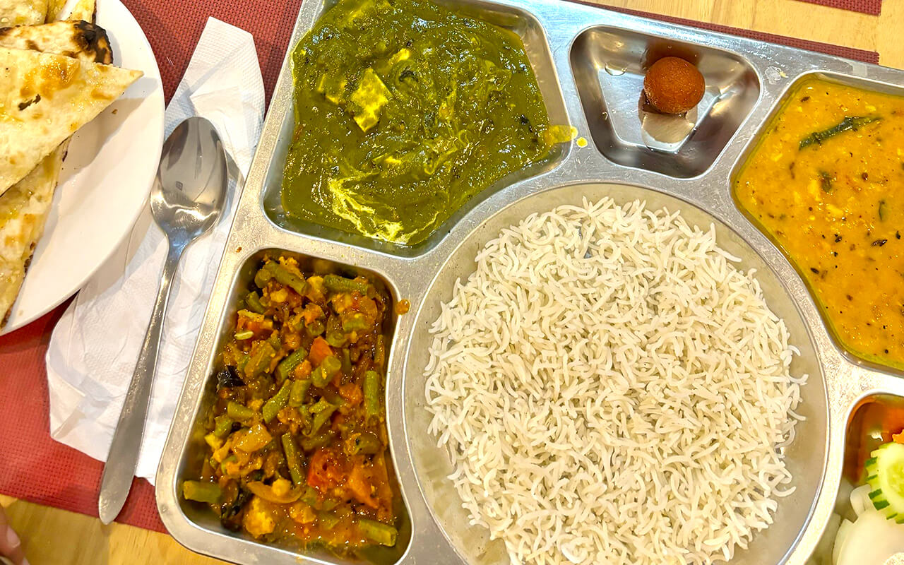 Curry and rice dish on a metal tray