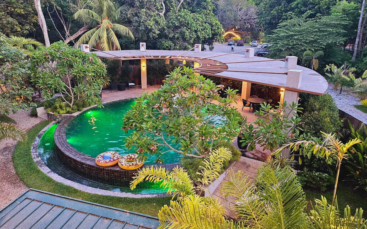 Outdoor hotel with a pool and trees 