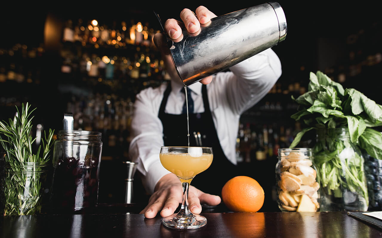 Bartender pouring cocktail