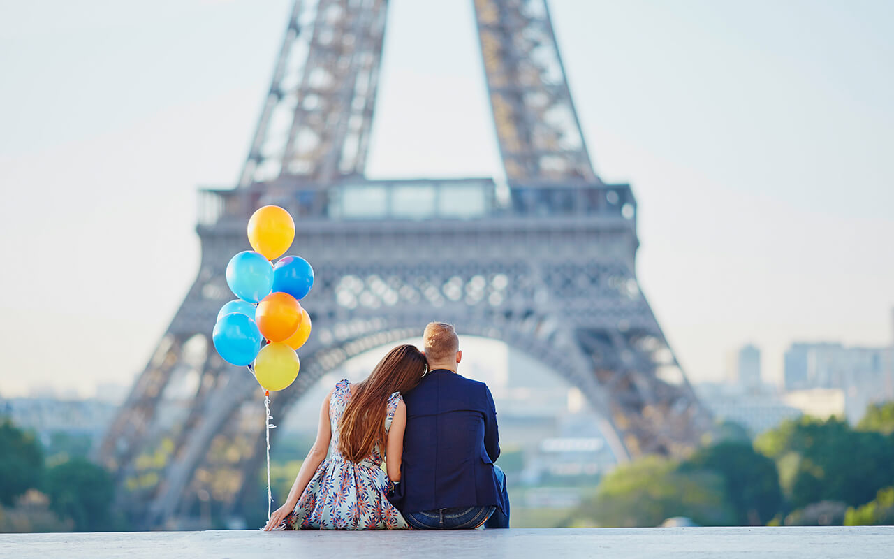 Couple with colorful balloons near the Eiffel tower