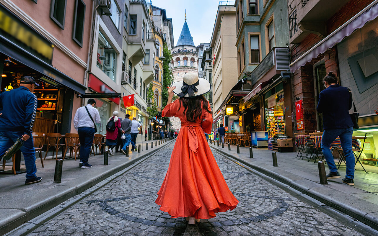 Woman standing at Galata tower in Istanbul, Turkey.