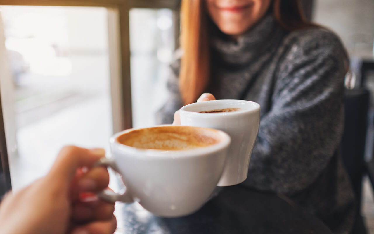 Couple drinking hot chocolate out of mugs