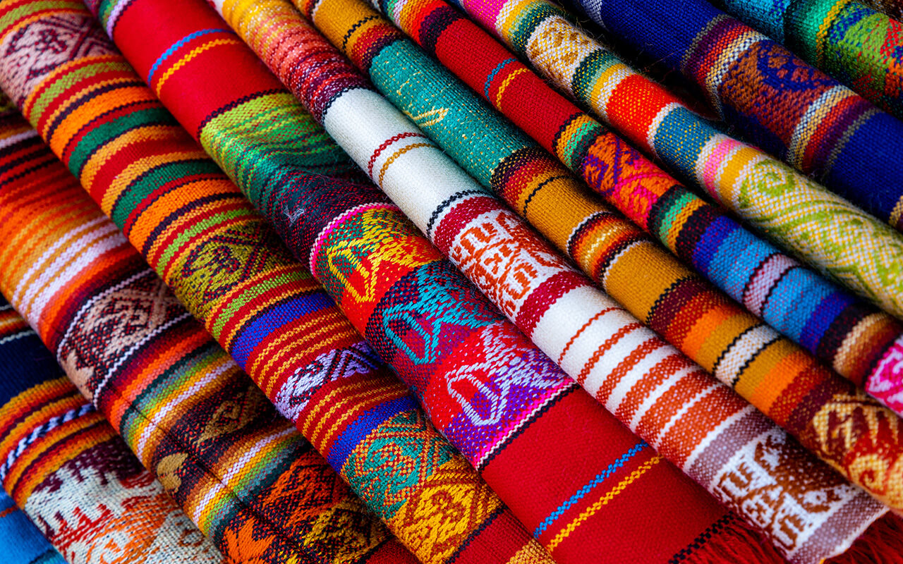 Colorful Andean fabric textiles on the local souvenir market in Otavalo, Ecuador. South America.