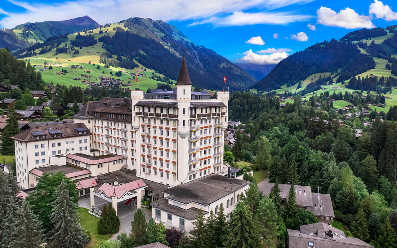 Gstaad - elegant and popular mountain ski resort in Swizerland, canton Bern. aerial drone panoramic view