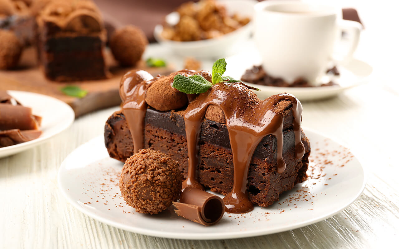 Chocolate cake with a chocolate truffle on the side and mint on top