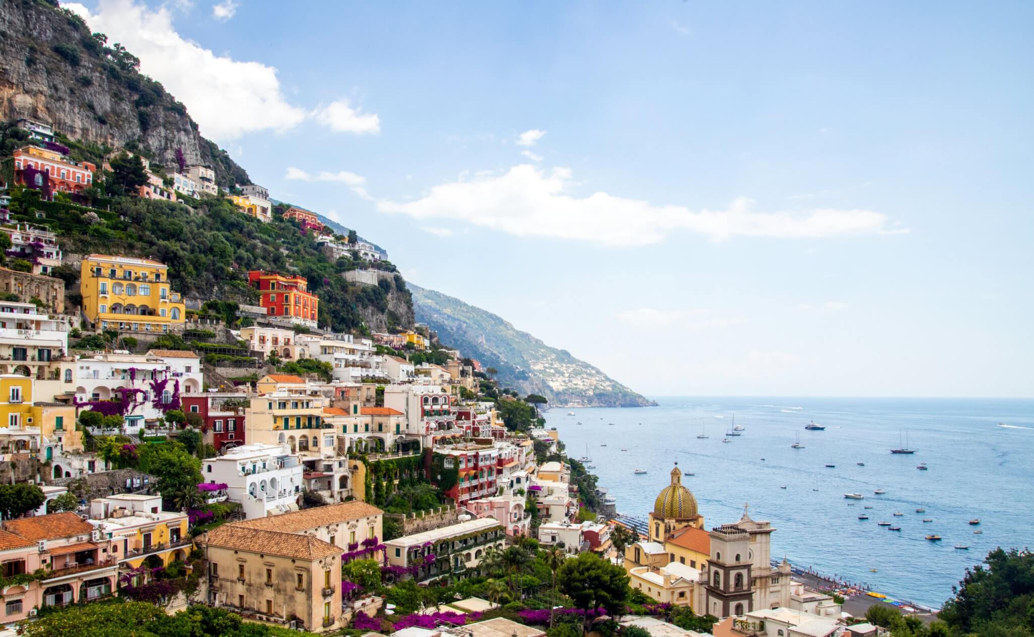 Colorful cliffside view of Positano, Italy overlooking the Amalfi Coast and Mediterranean Sea