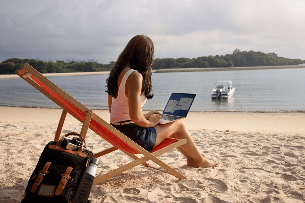 woman on the beach on a laptop