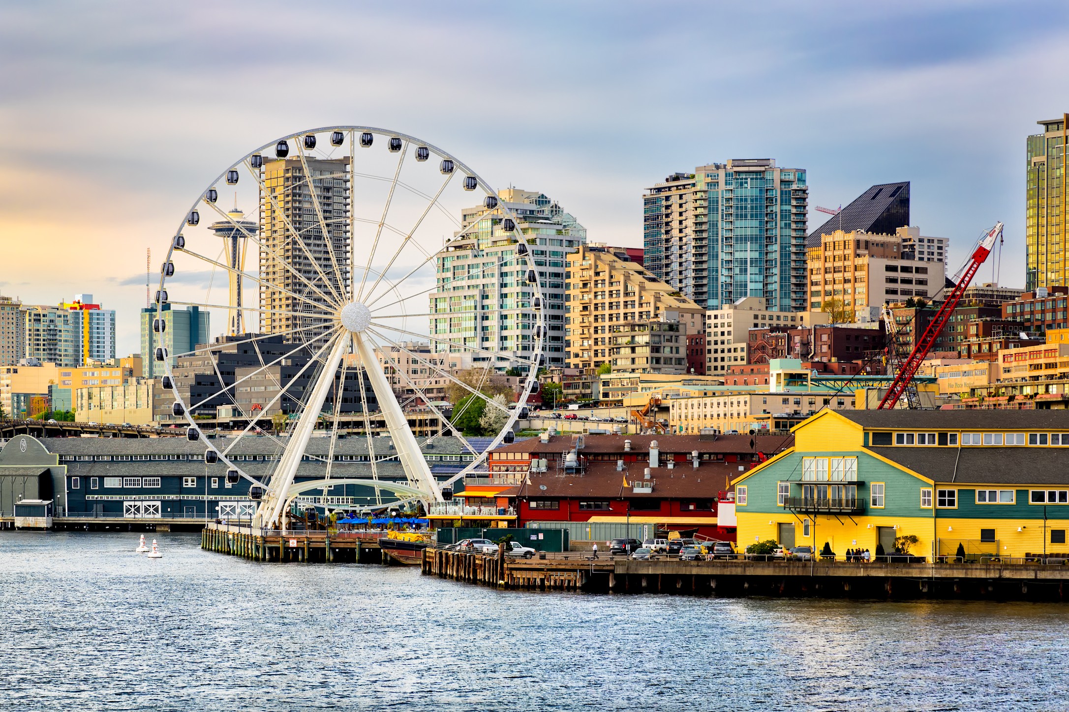 Seattle waterfront and skyline at dusk with gold light