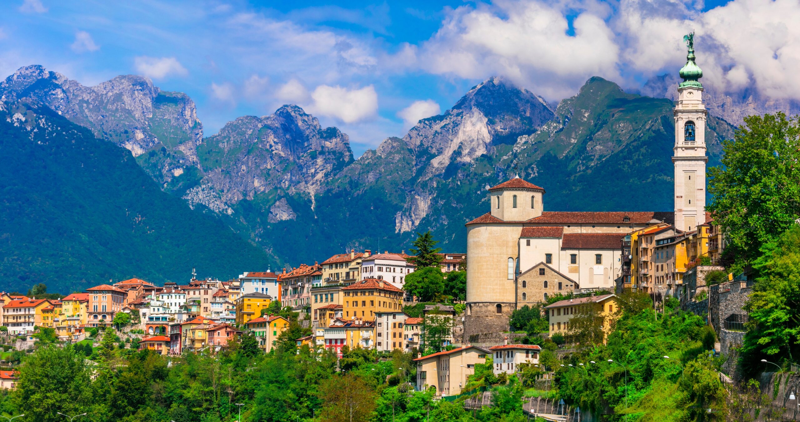 Travel in northern Italy - beautiful Belluno town surrounded by impressive Dolomite mountains
