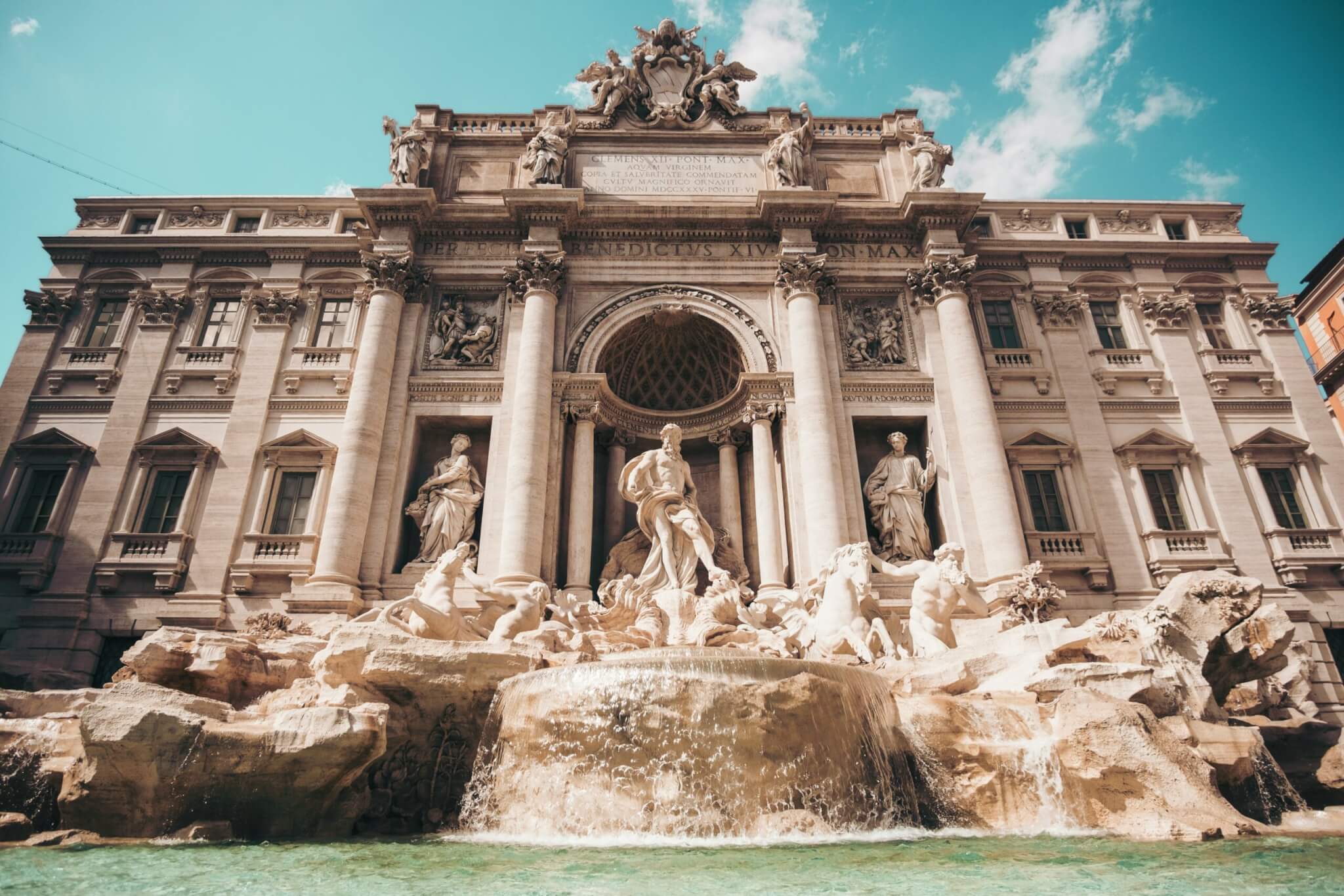 Trevi Fountain in Rome Italy with historic architecture and blue sky