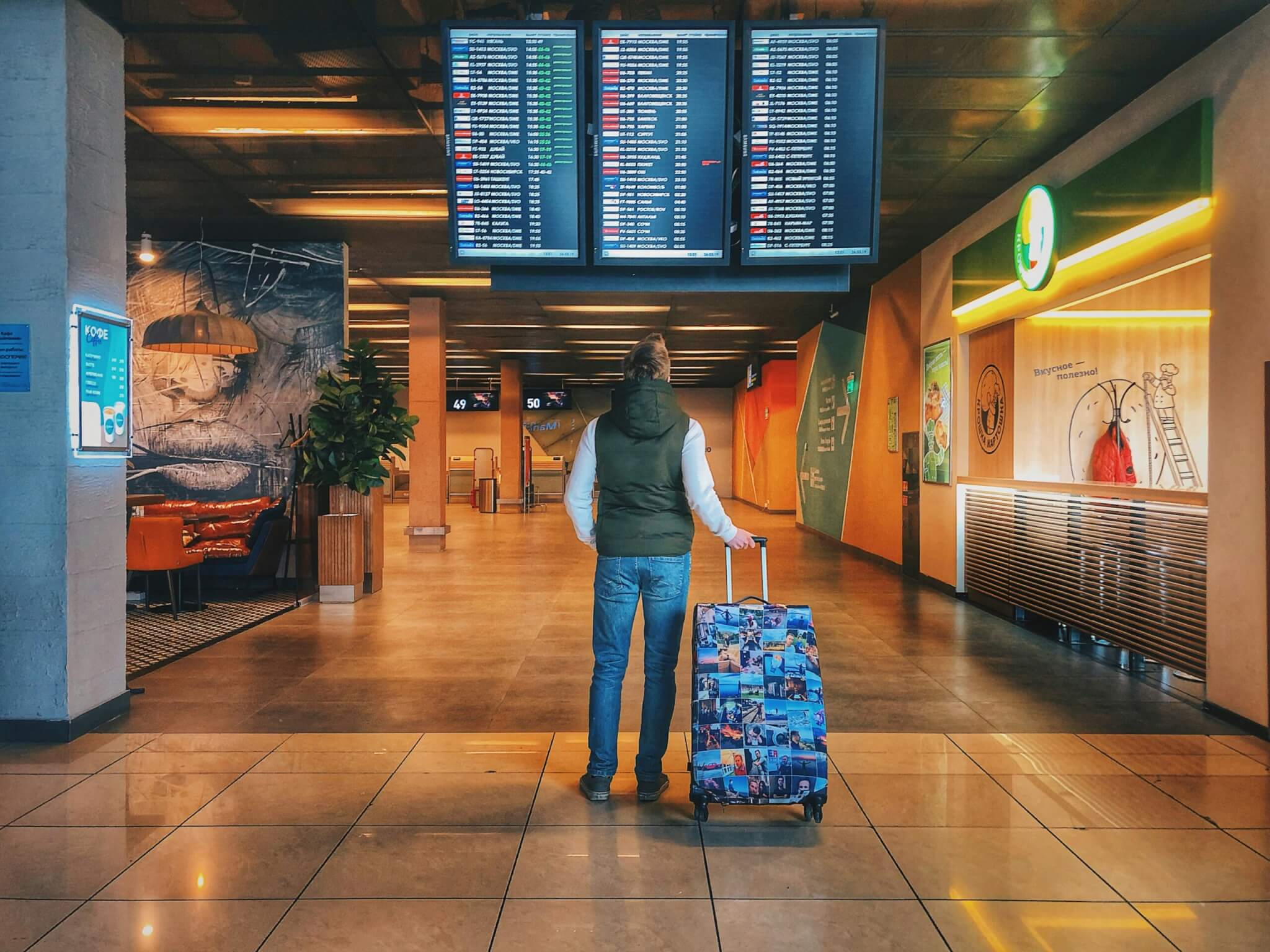 person in an airport with their luggage