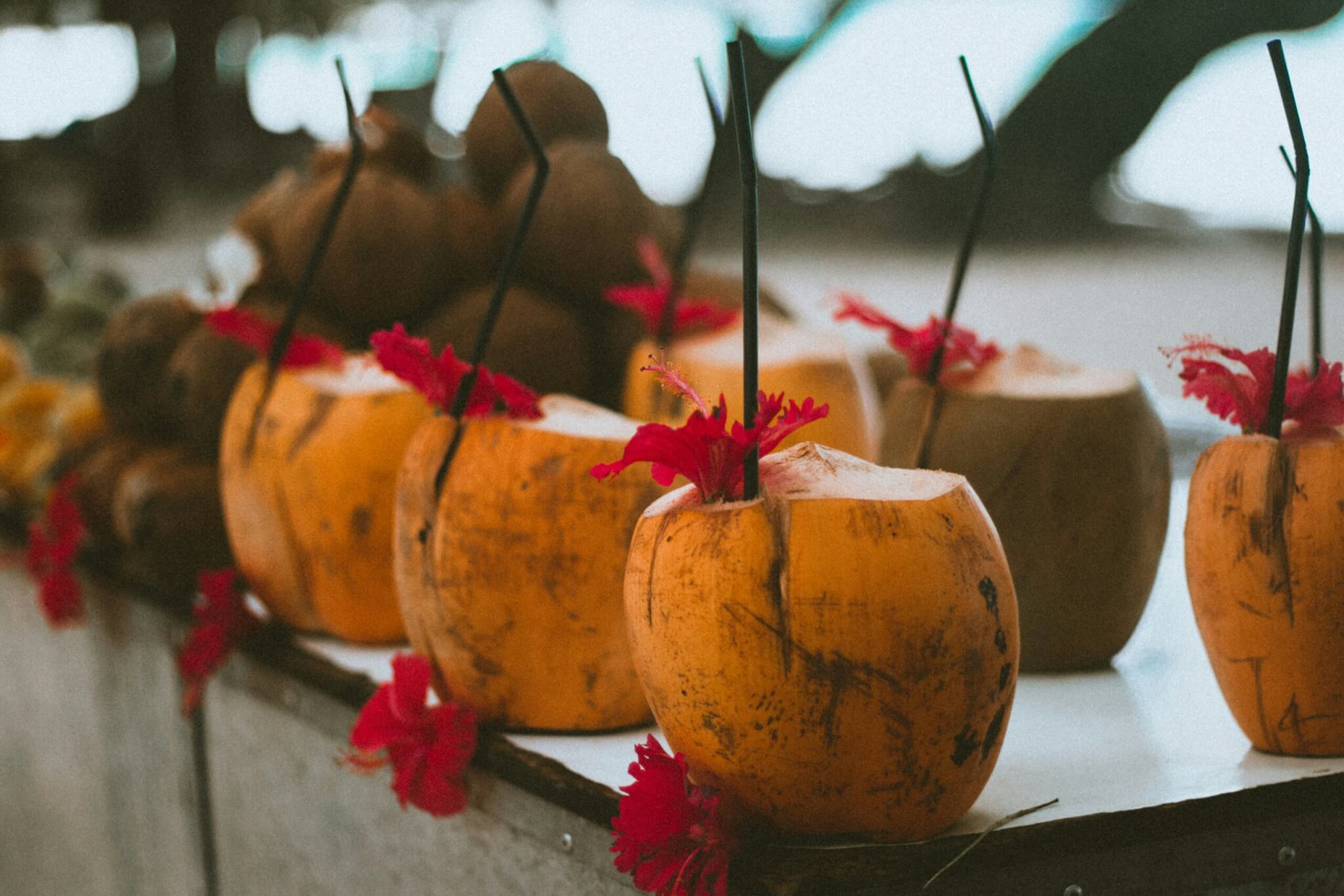 Fresh coconut drinks on a table at a tropical beach destination