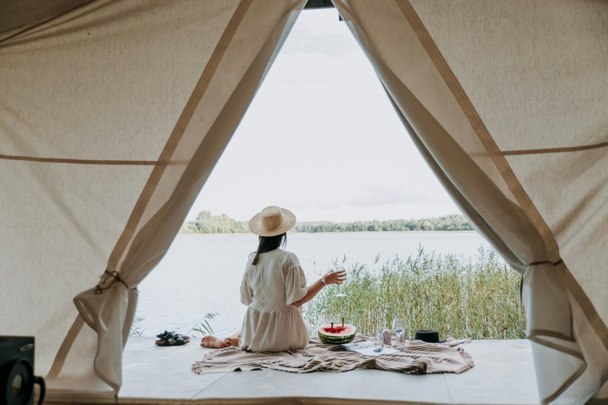 woman eating a meal near her tent