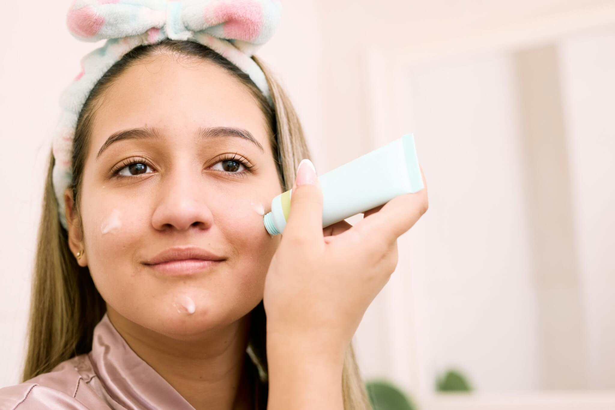 Woman applying sunscreen