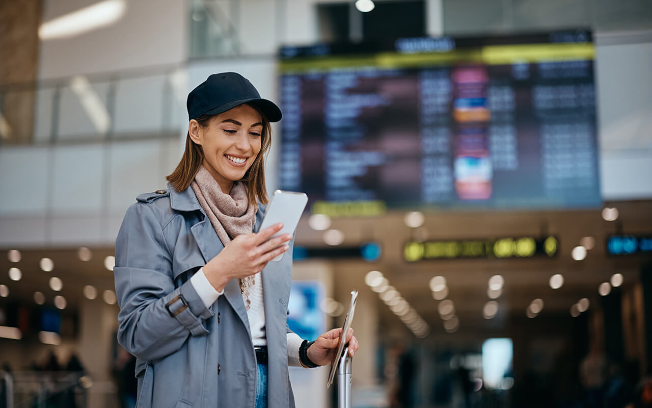 Woman on her phone at an airport