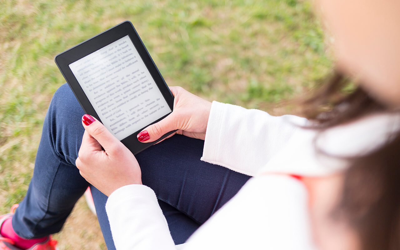 Woman reading on a kindle 