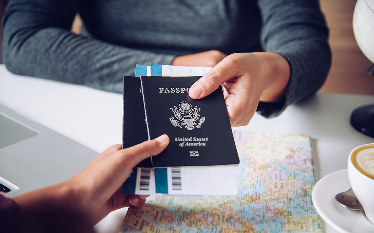 Person handing their passport to another person
