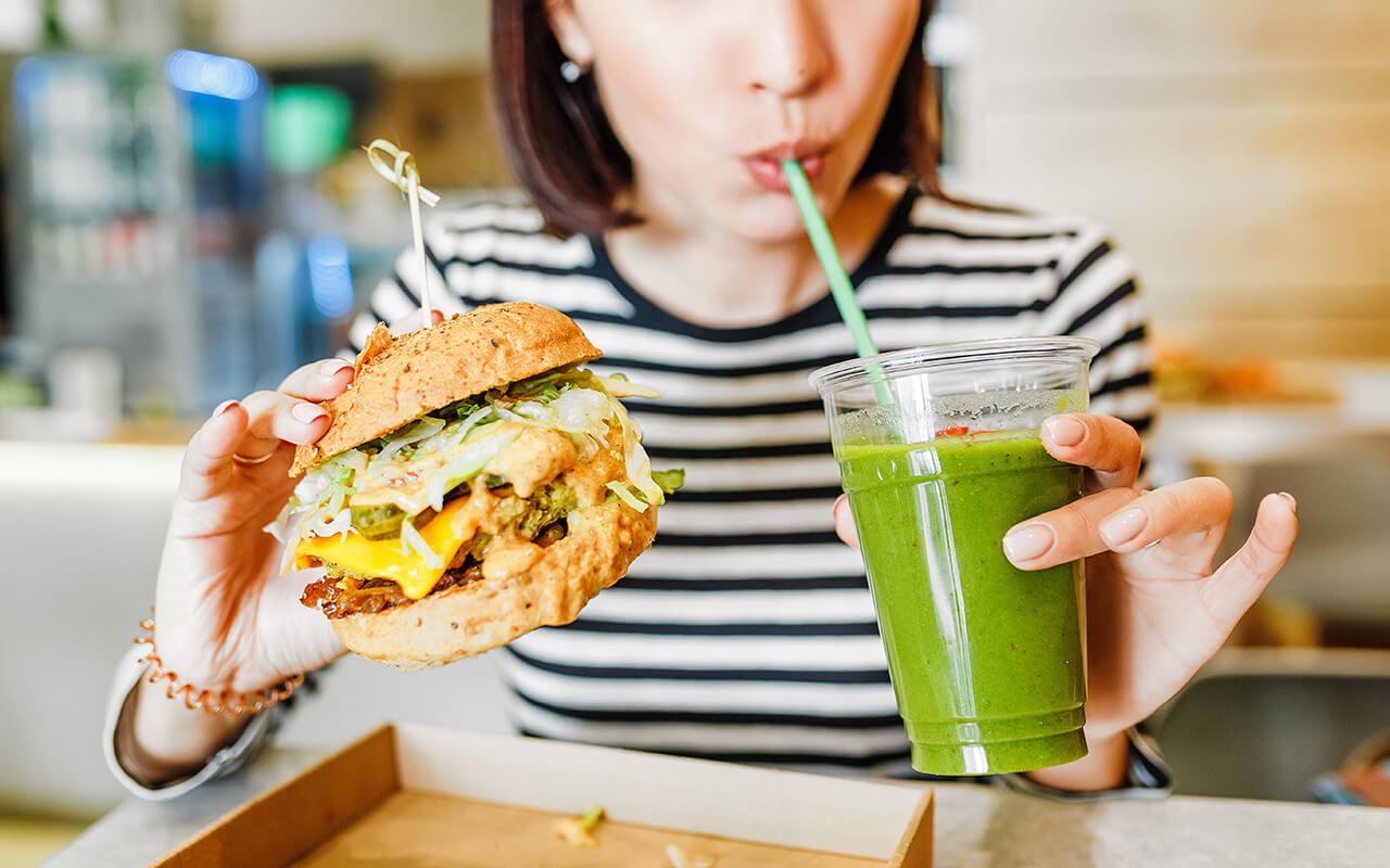 Vegan burger and green smoothie representing vegan-friendly destinations and plant-based travel