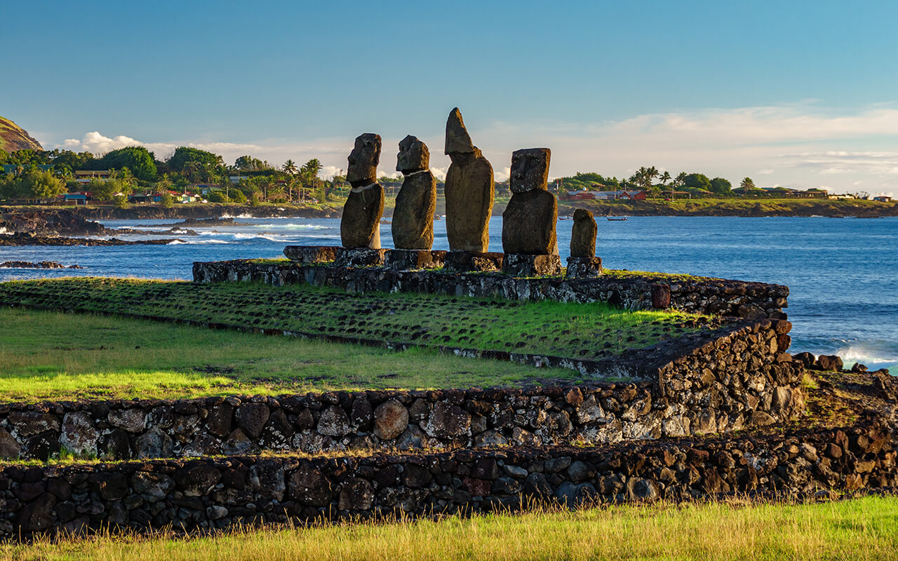 Ahu Tahai against ocean and Hanga Roa in Rapa Nui