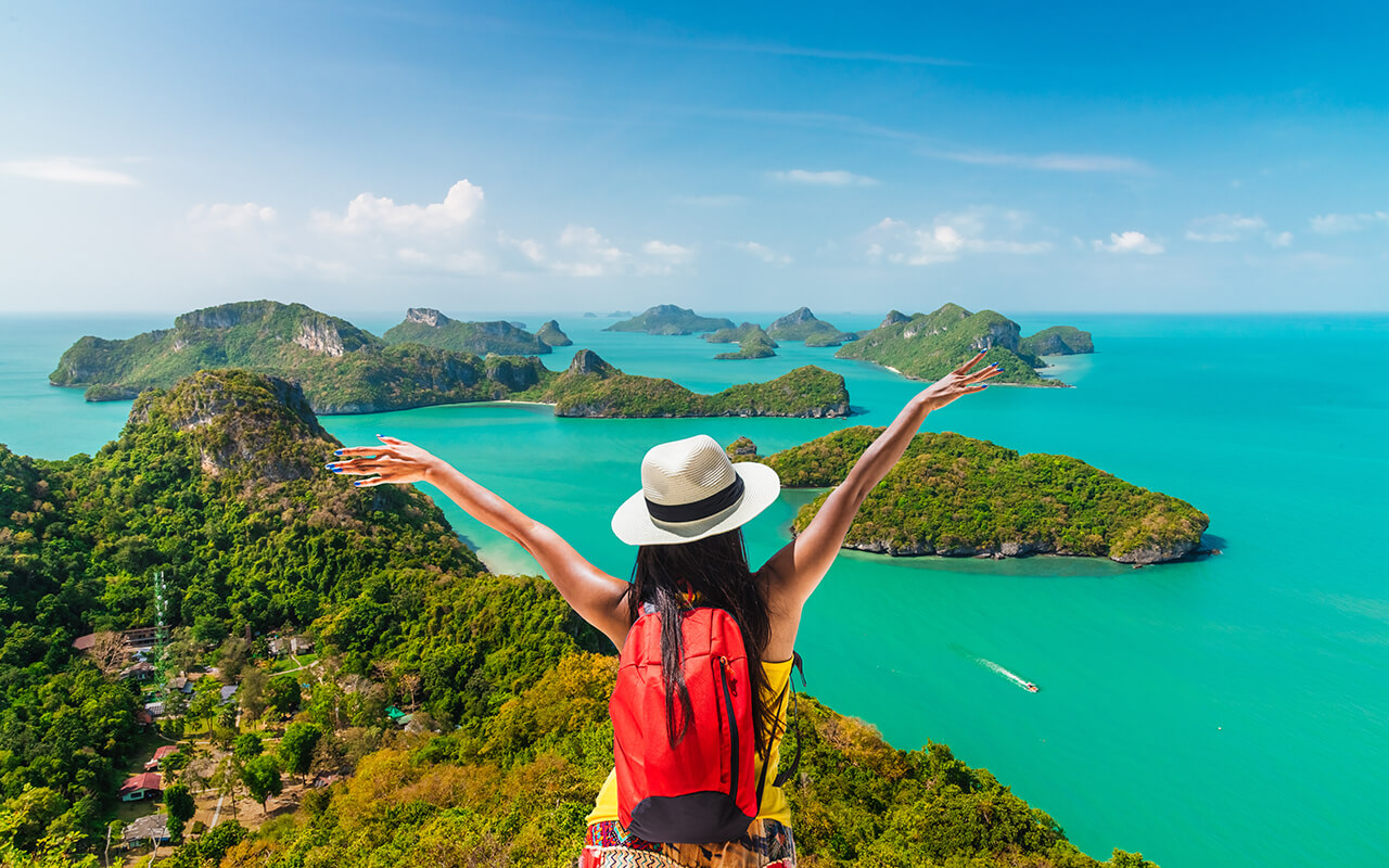 Backpack traveler woman on top group of island joy view beautiful nature scenic landscape