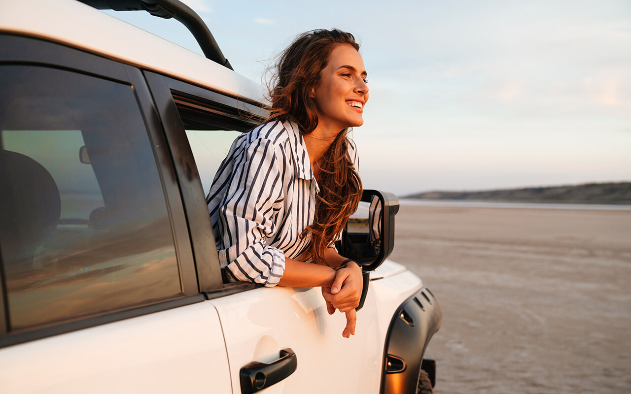 Woman leaning out a car window