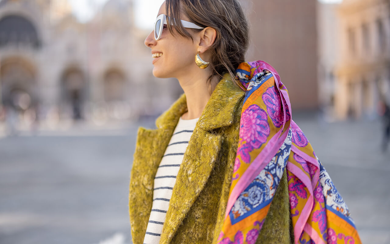 Woman wearing a coat and scarf outdoors