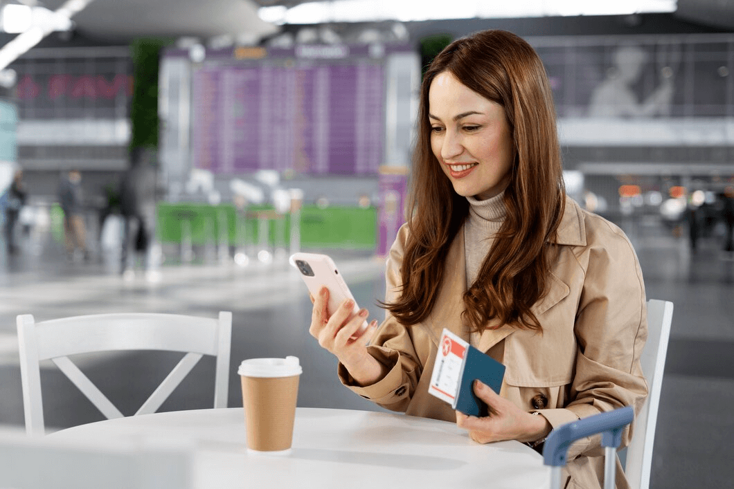 Woman at airport looking at phone