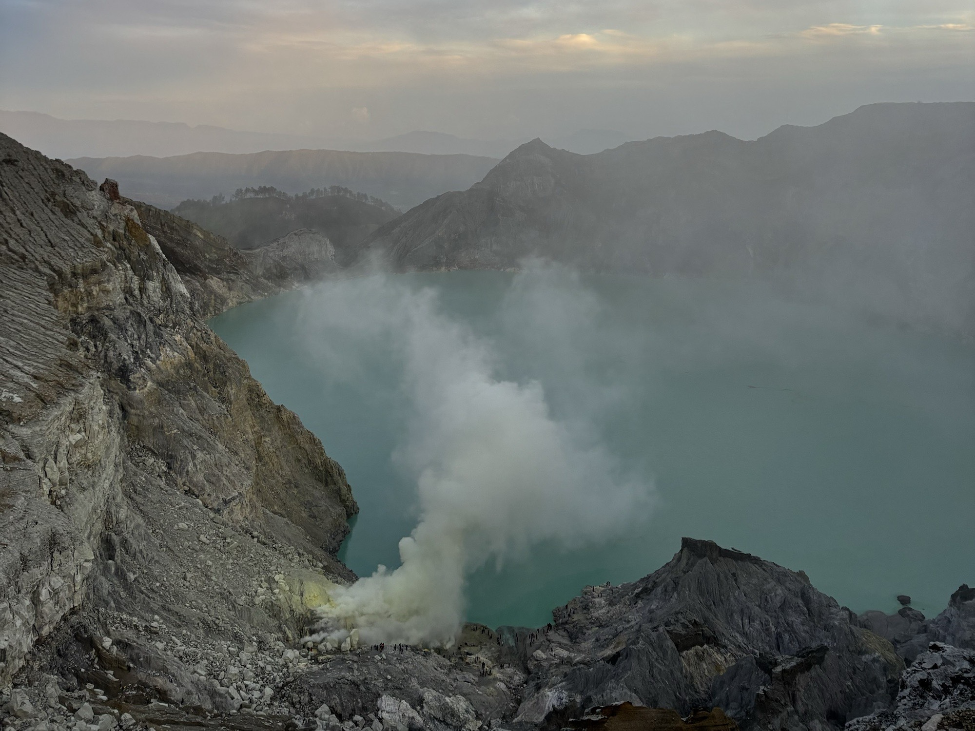 Sunrise views over the lake, as the sulfur clouds flow through the sky
