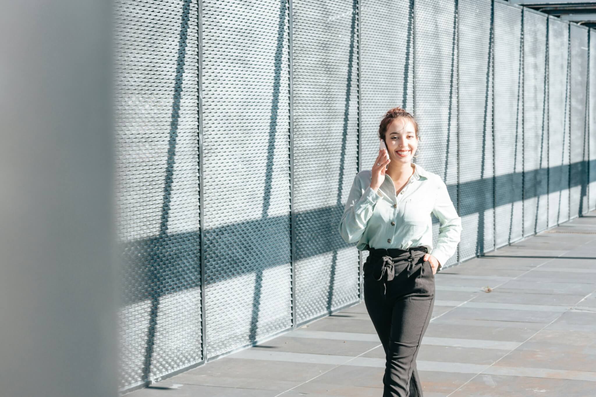 Woman walking on sidewalk