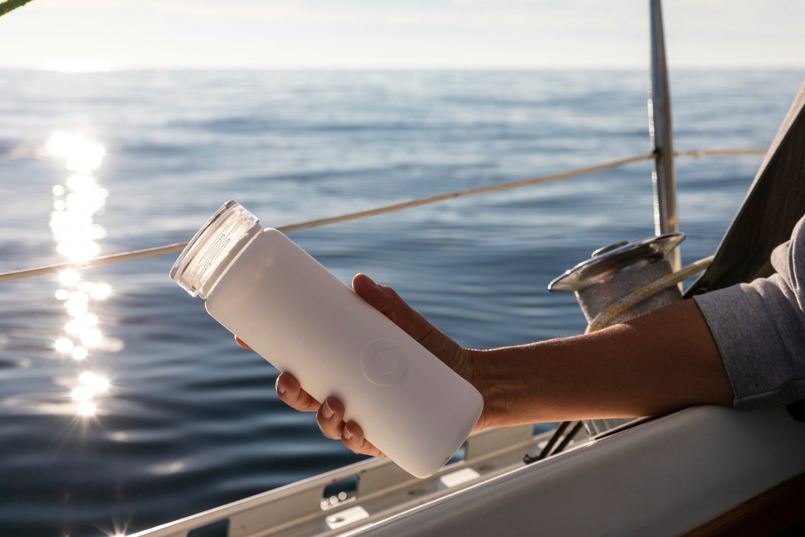 person holding a water bottle on a boat