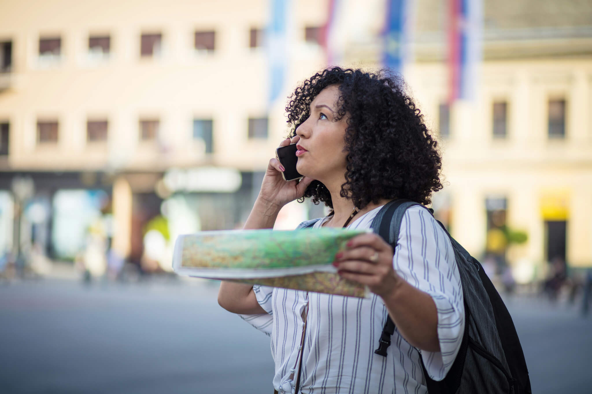Woman with a map on the phone 
