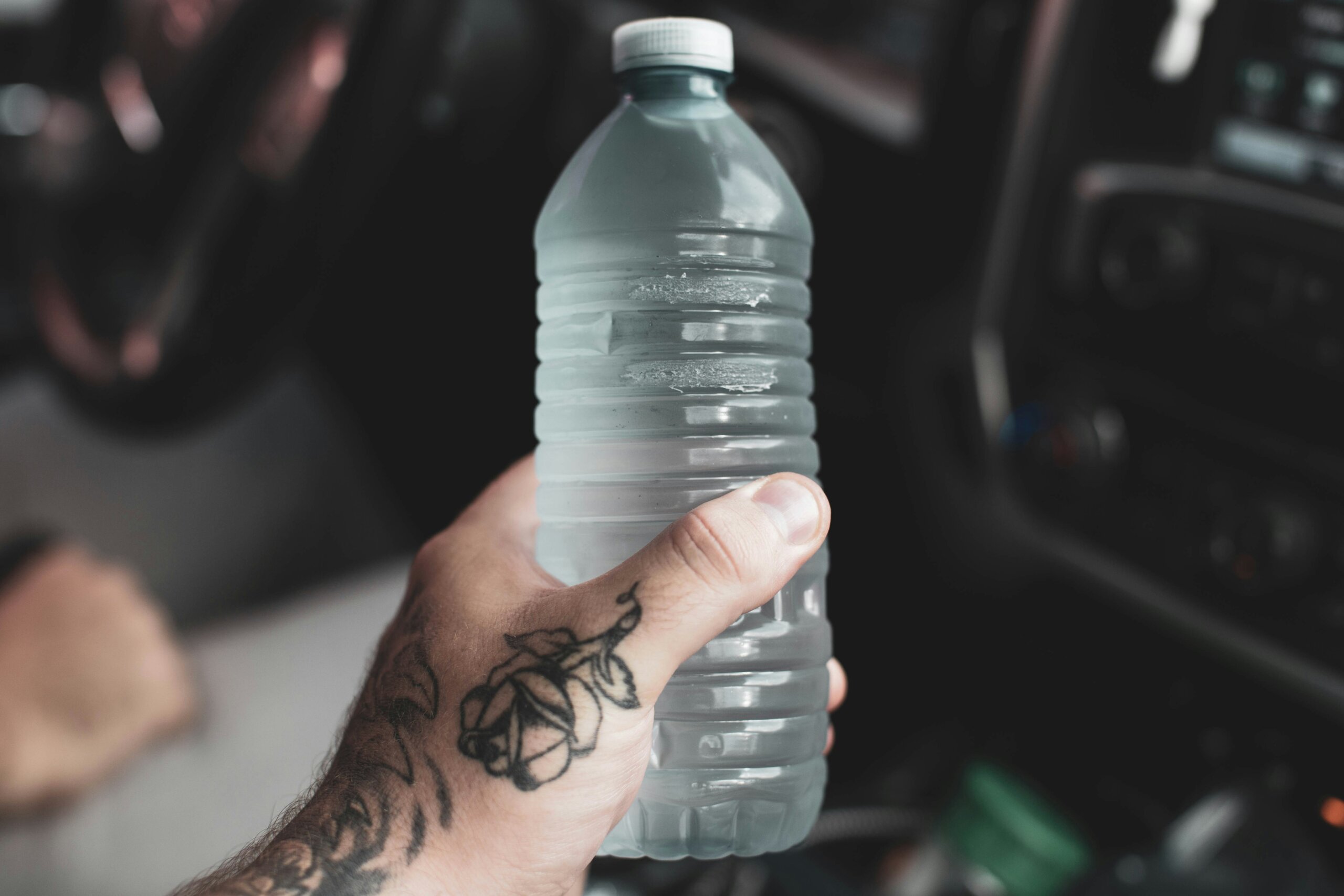 person holding water bottle