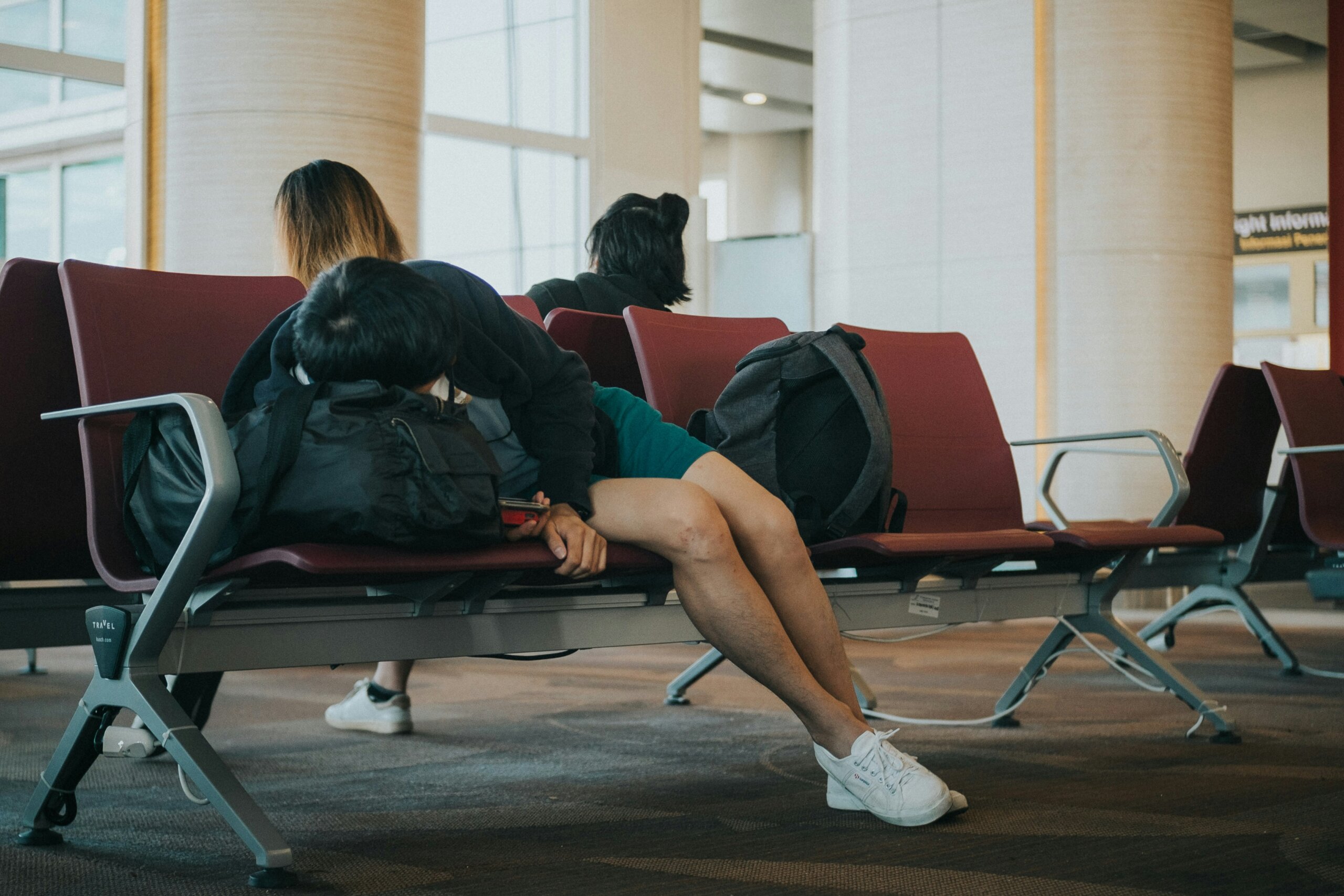 person falling asleep in the airport