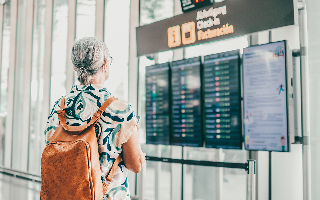 Woman looking at arrival times at the airport