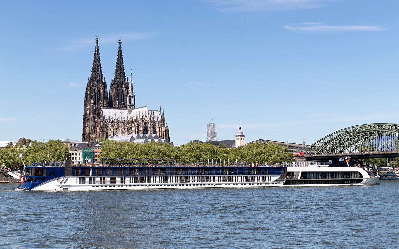 river cruise ship AMASTELLA passing Cologne Cathedral. 