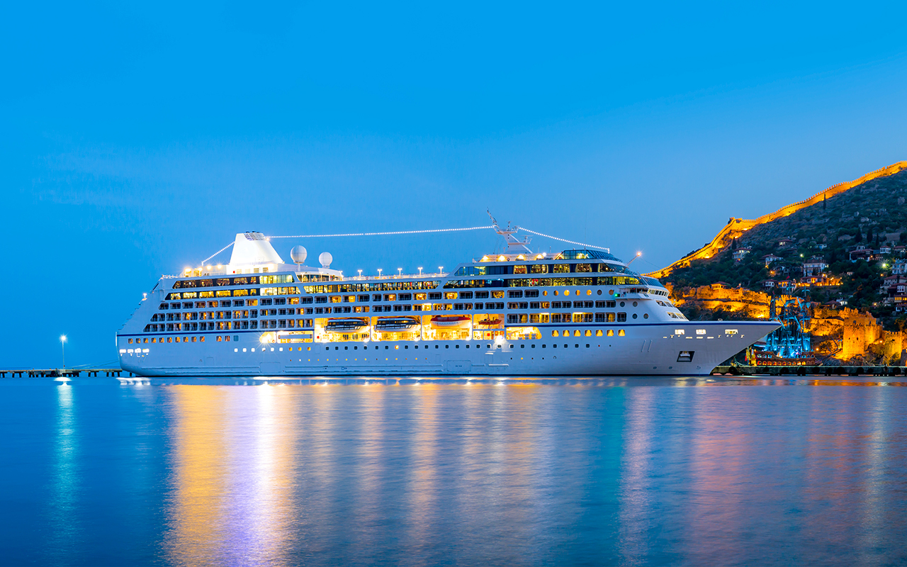 Beautiful white giant luxury cruise ship on stay at Alanya harbor