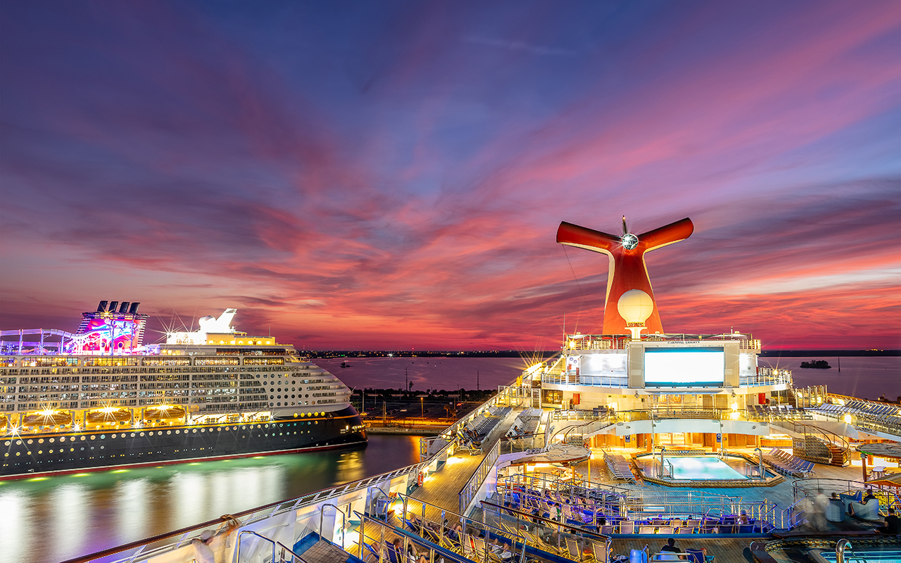 Carnival Liberty and Disney Dream cruise ships docked in Port Canaveral at sunset