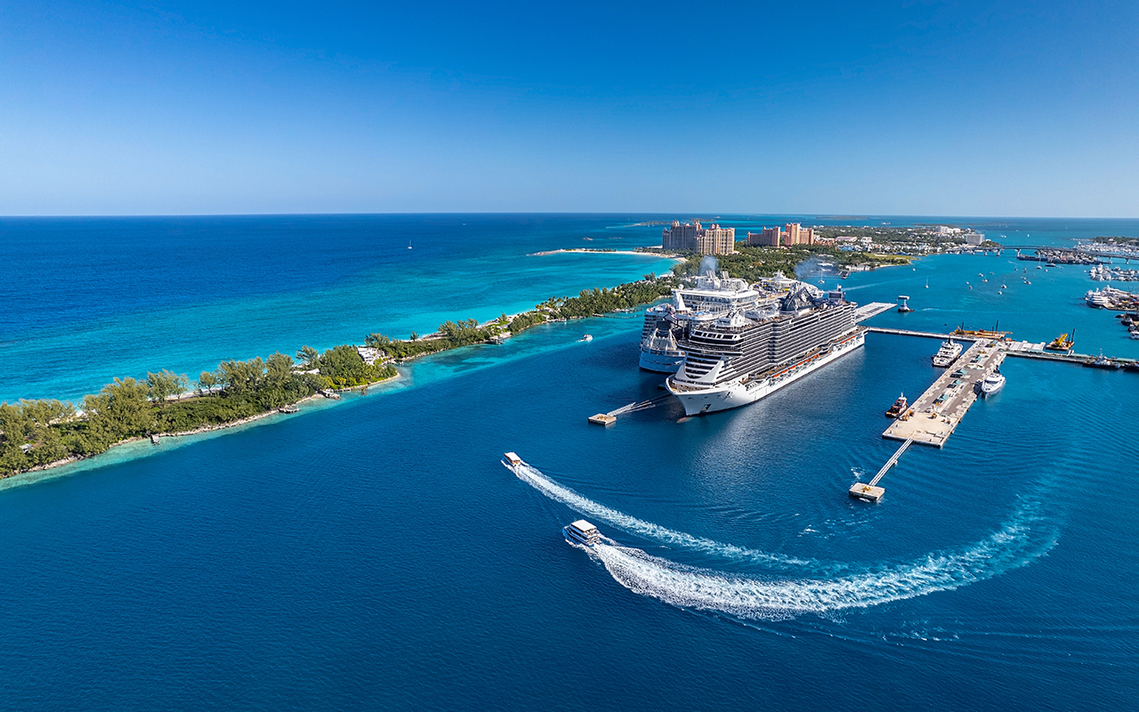The drone aerial view of cruise ships in the clear blue Caribbean ocean docked in the port of Nassau, Bahamas.