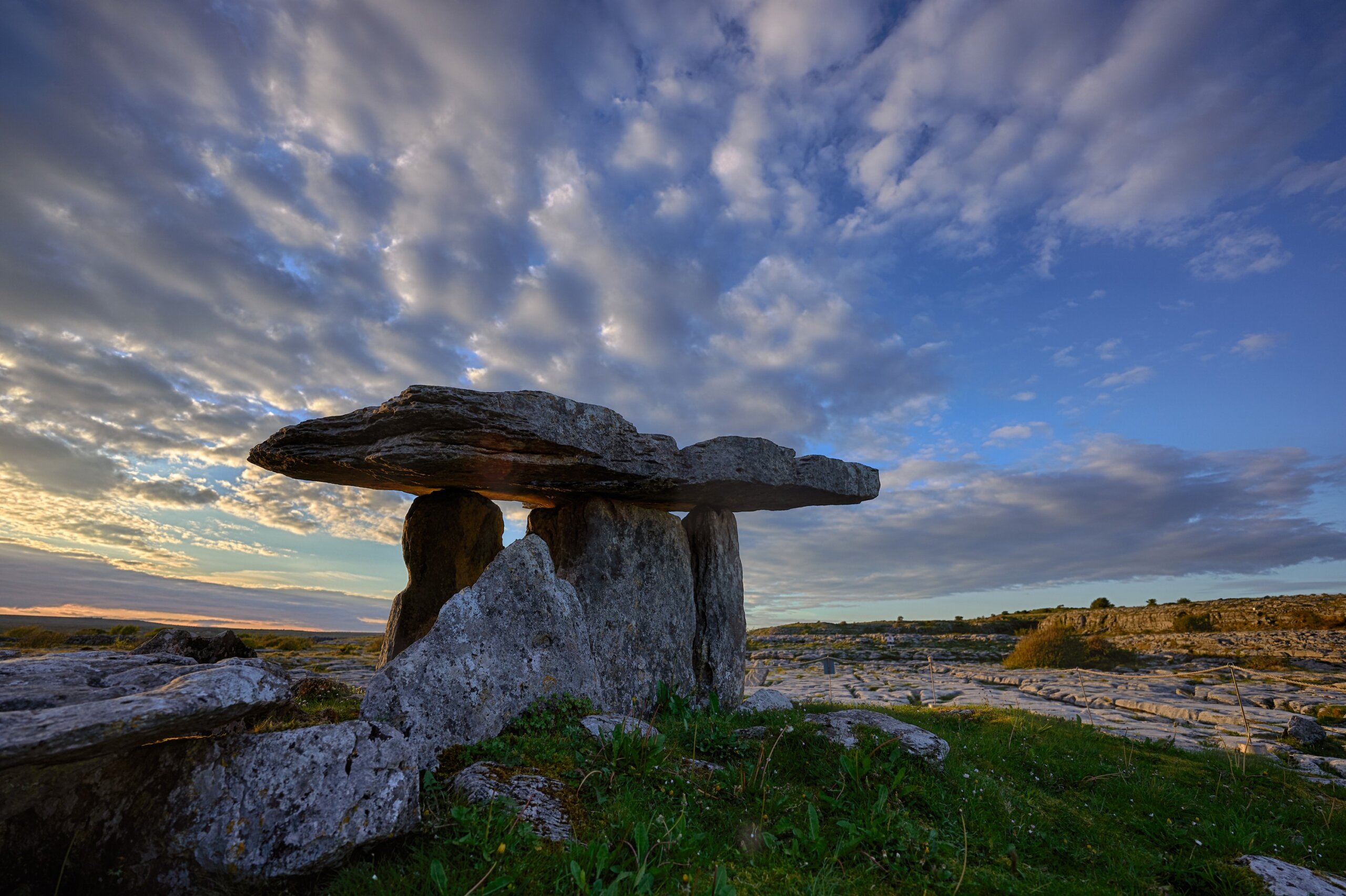Sunset over Poulnabrone dolmen an ancient portal tomb in the Burren, County Clare, in the west of Ireland.

