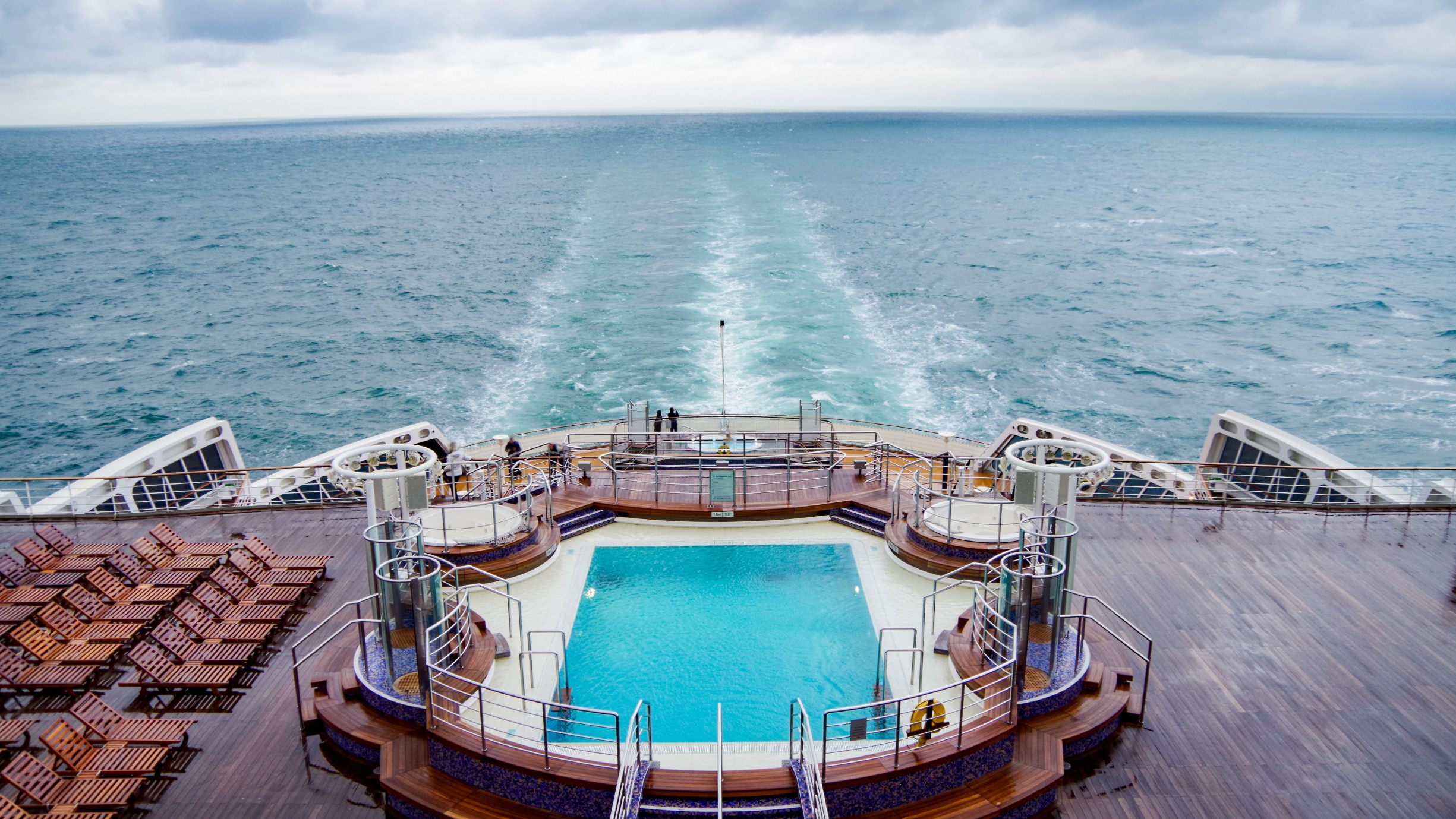 Sun loungers and deck chairs on luxury Cunard oceanliner, cruiseship or cruise ship liner QM2 Queen Mary 2 on after pool deck