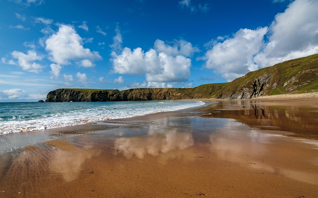 Slow shutter exposure of the Silver Strand, a horse-shoe shaped beach situated at Malin Beg, near Glencolmcille, in south-west County Donegal, Ireland