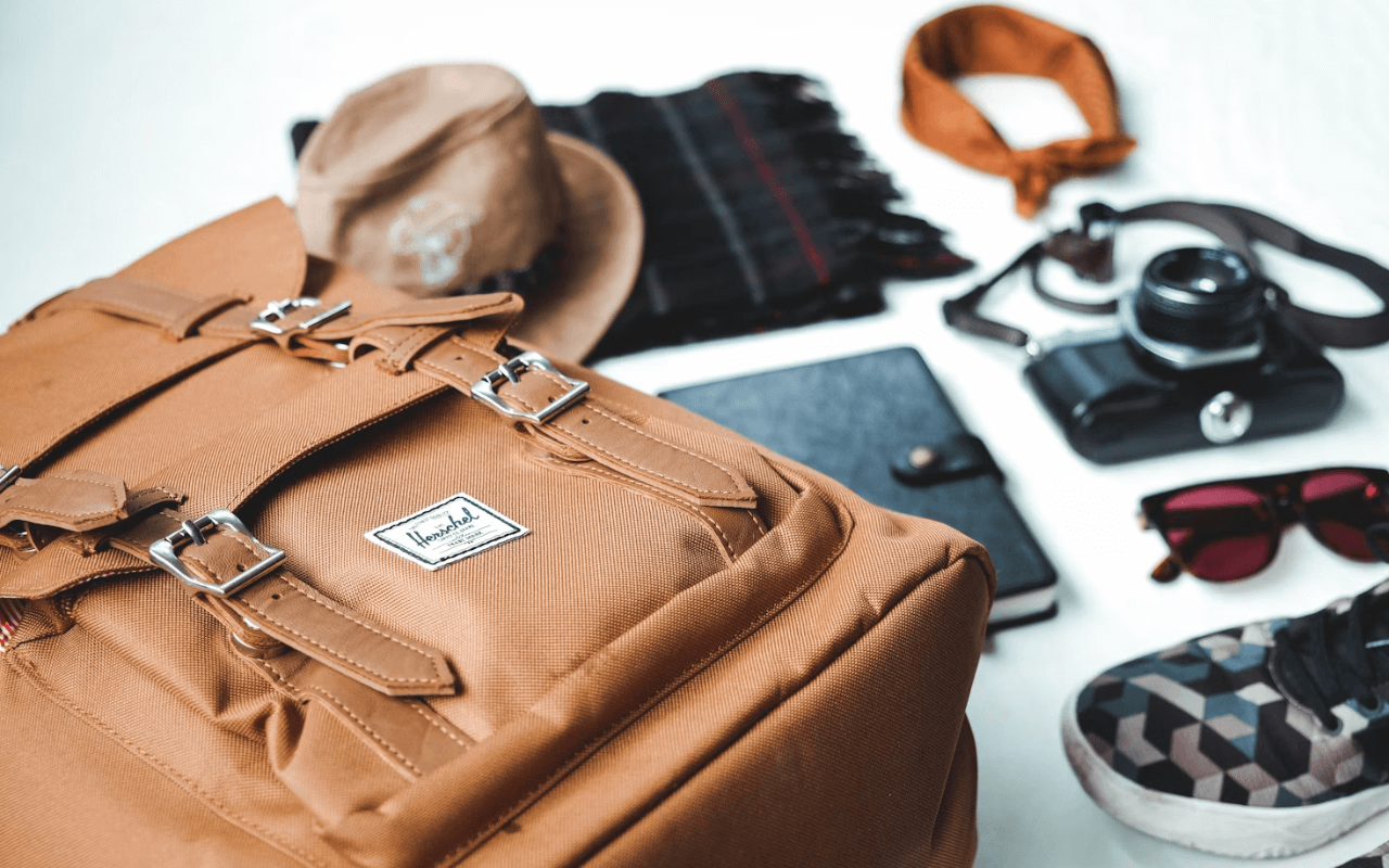 Backpack with clothes and other objects laid flat