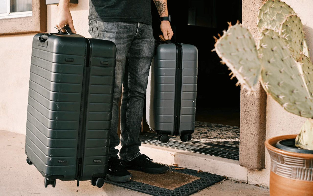 Man carrying two suitcases